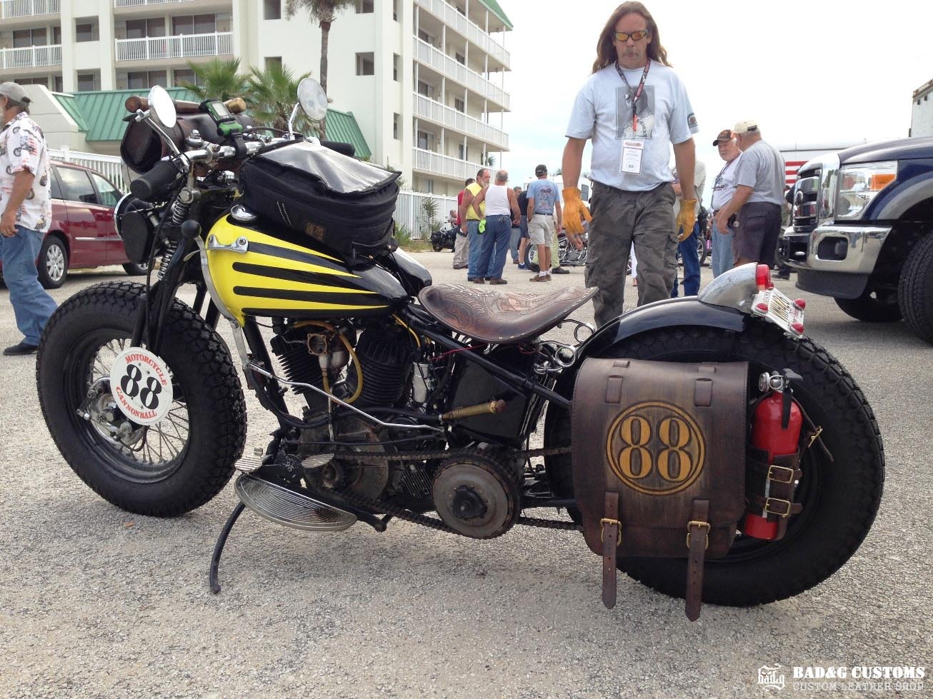We’re proud to showcase a custom-made seat and saddlebags set crafted specifically for Doug Wothke, the legendary round-the-world motorcycle traveler. Made from hand-tooled and antiqued veg-tan leather, this set took countless hours of expert craftsmanship to complete. Designed for both durability and vintage authenticity, it will accompany him on the 2014 Cannonball Motorcycle Race, as he tackles this grueling challenge aboard his classic Harley-Davidson JD motorcycle. A true tribute to adventure!