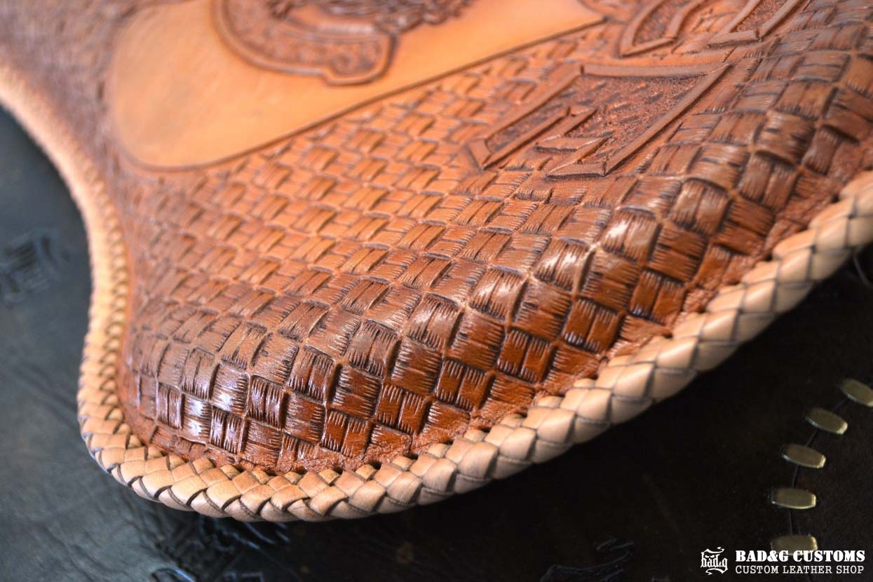 "ACE Pin-Up Girl" design hand tooled and braided on a chopper solo seat. Veg tan leather with kangaroo lace.